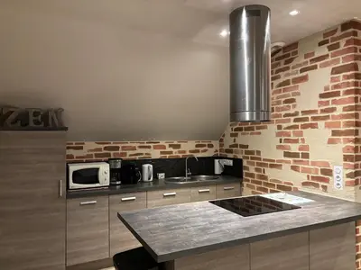 Cuisine ou kitchenette dans l'établissement Aqua Zen avec Piscine - Breizh location