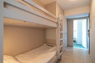 Un ou plusieurs lits dans un hébergement de l'établissement Les Thermes 521 - Appt proche plage avec piscine partagée