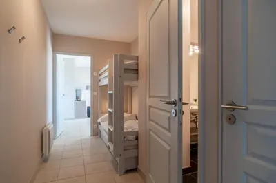 Un ou plusieurs lits dans un hébergement de l'établissement Les Thermes 521 - Appt proche plage avec piscine partagée