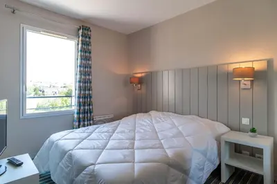 Un ou plusieurs lits dans un hébergement de l'établissement Les Thermes 521 - Appt proche plage avec piscine partagée