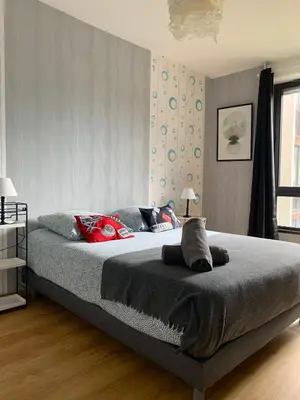 Un ou plusieurs lits dans un hébergement de l'établissement L'Escale - appartement spacieux au calme