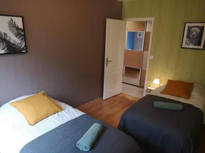 Un ou plusieurs lits dans un hébergement de l'établissement L'Escale - appartement spacieux au calme