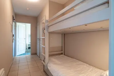 Un ou plusieurs lits dans un hébergement de l'établissement Les Thermes 515 - Appt avec piscine partagée