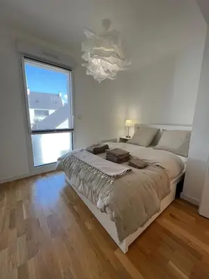Un ou plusieurs lits dans un hébergement de l'établissement Appartement vue mer