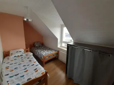 Un ou plusieurs lits dans un hébergement de l'établissement Agréable petit T3, à proximité de Quimper