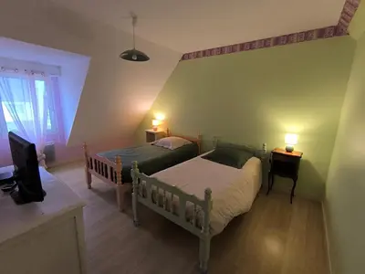 Un ou plusieurs lits dans un hébergement de l'établissement Gîte Arums, meublé 3 étoiles, proche mer (800 mètres)