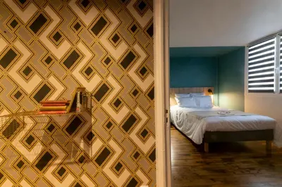 Un ou plusieurs lits dans un hébergement de l'établissement Mc Guigan's appart hôtel appartement