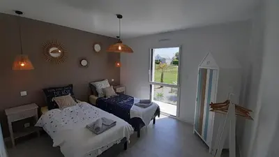 Un ou plusieurs lits dans un hébergement de l'établissement Maison neuve à deux pas de la superbe plage des Amiets
