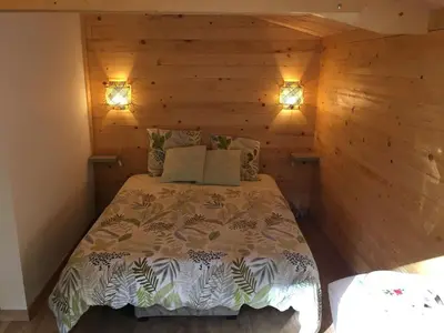 Un ou plusieurs lits dans un hébergement de l'établissement Cabane au milieu des bois