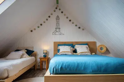 Un ou plusieurs lits dans un hébergement de l'établissement Ti vaen I Maison traditionnelle bretonne & Sauna
