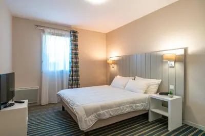 Un ou plusieurs lits dans un hébergement de l'établissement Les Thermes 500 - Appt avec piscine partagée