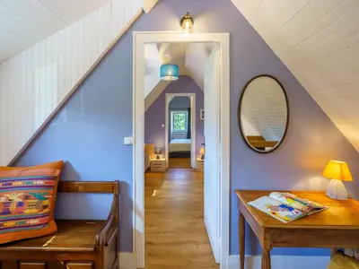Coin salon dans l'établissement Holiday Home la chaumière de Quélarn by Interhome