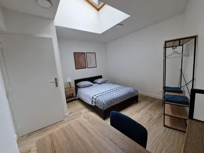 Un ou plusieurs lits dans un hébergement de l'établissement Cosy & Work - 2 chambres- Centre