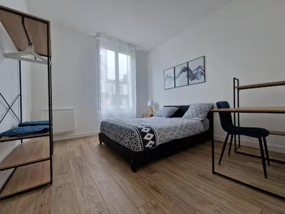 Un ou plusieurs lits dans un hébergement de l'établissement Cosy & Work - 2 chambres- Centre