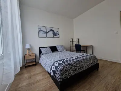 Un ou plusieurs lits dans un hébergement de l'établissement Cosy & Work - 2 chambres- Centre