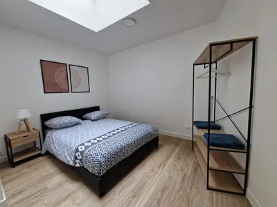 Un ou plusieurs lits dans un hébergement de l'établissement Cosy & Work - 2 chambres- Centre