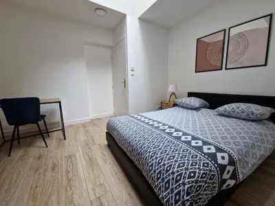 Un ou plusieurs lits dans un hébergement de l'établissement Cosy & Work - 2 chambres- Centre
