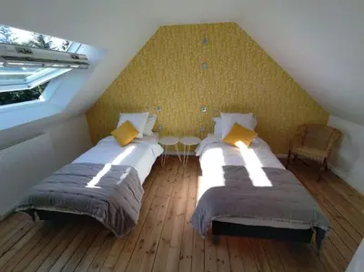 Un ou plusieurs lits dans un hébergement de l'établissement La Maison de Tante Yvonne - Gîte de Kerblaise