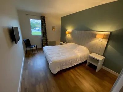 Un ou plusieurs lits dans un hébergement de l'établissement Le Cabellou - Appt avec piscine commune