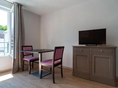 Télévision ou salle de divertissement dans l'établissement Vacancéole - Les Rives de Pont-Aven