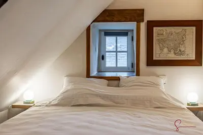 Un ou plusieurs lits dans un hébergement de l'établissement La maison du Cocher