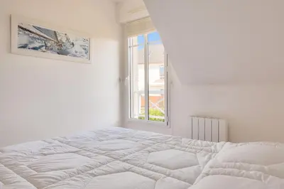 Un ou plusieurs lits dans un hébergement de l'établissement Proche plages et commerces, appartement pour 4