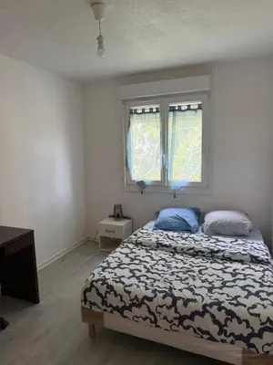 Un ou plusieurs lits dans un hébergement de l'établissement Appartement T4