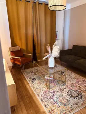 Coin salon dans l'établissement L Appartement - Siam vue Capucins