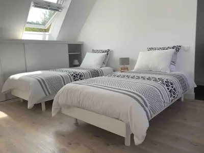 Un ou plusieurs lits dans un hébergement de l'établissement Maison spacieuse 120 m plage de la grève blanche