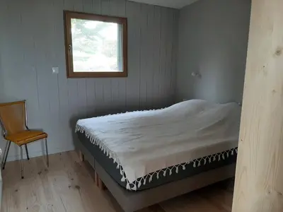 Un ou plusieurs lits dans un hébergement de l'établissement Maison en bois vue sur mer en Bretagne 5 couchages