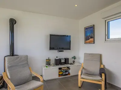 Télévision ou salle de divertissement dans l'établissement Holiday Home Ty Mamm by Interhome
