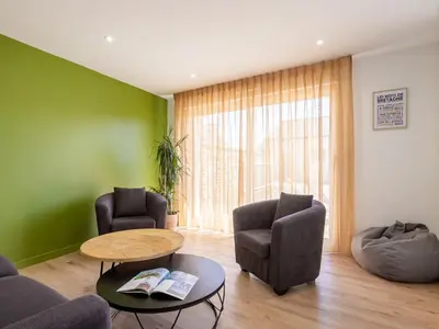 Coin salon dans l'établissement Holiday Home La Roselière by Interhome