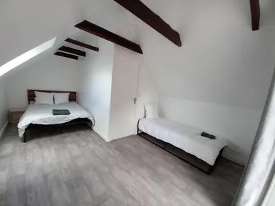 Un ou plusieurs lits dans un hébergement de l'établissement Odet, maison avec grande terrasse
