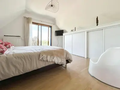 Un ou plusieurs lits dans un hébergement de l'établissement Maison familiale chaleureuse à Saint-Évarzec avec terrasse