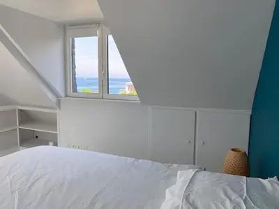 Un ou plusieurs lits dans un hébergement de l'établissement Maison avec vue mer et accès plage à Plougasnou