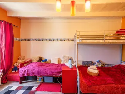 Un ou plusieurs lits dans un hébergement de l'établissement Holiday Home la maison du bonheur by Interhome