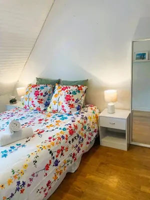 Un ou plusieurs lits dans un hébergement de l'établissement Chambre dans maison individuelle