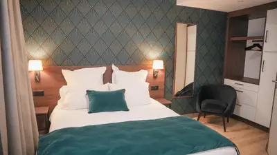 Un ou plusieurs lits dans un hébergement de l'établissement KoonTy - Chambres et Appartements à Landerneau