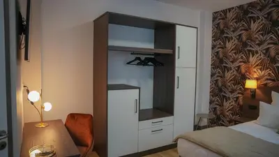 Un ou plusieurs lits dans un hébergement de l'établissement KoonTy - Chambres et Appartements à Landerneau