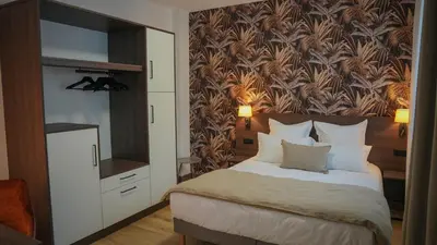 Un ou plusieurs lits dans un hébergement de l'établissement KoonTy - Chambres et Appartements à Landerneau