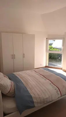 Un ou plusieurs lits dans un hébergement de l'établissement Maison Spacieuse avec Terrasse extérieure