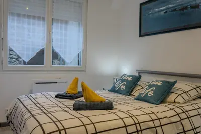 Un ou plusieurs lits dans un hébergement de l'établissement Ti Gat- vue mer - wifi