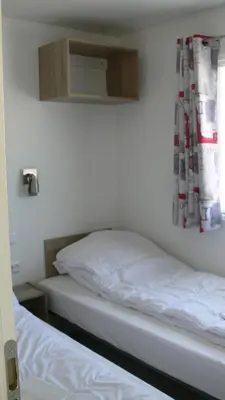Un ou plusieurs lits dans un hébergement de l'établissement Camping Lizoé