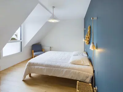 Un ou plusieurs lits dans un hébergement de l'établissement Maison avec jardin pour 10 personnes à Penmarch