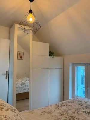 Un ou plusieurs lits dans un hébergement de l'établissement Charmante maison proche de la mer et des commerces