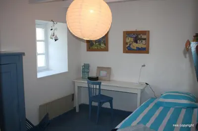 Un ou plusieurs lits dans un hébergement de l'établissement Gîte des Hortensias - Old farmhouse - Sea view
