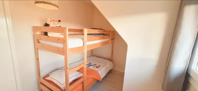 Un ou plusieurs lits dans un hébergement de l'établissement Face à l'océan accès direct à la plage, la maison des dunes