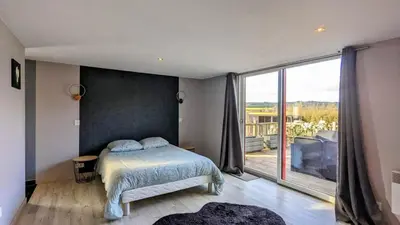 Un ou plusieurs lits dans un hébergement de l'établissement Chalet bois
