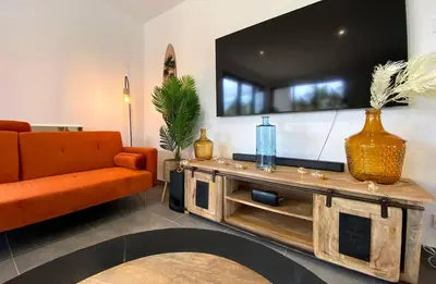 Télévision ou salle de divertissement dans l'établissement Les Maisons Côté Ouest