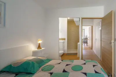 Un ou plusieurs lits dans un hébergement de l'établissement Ty Koad - maison avec grande terrasse